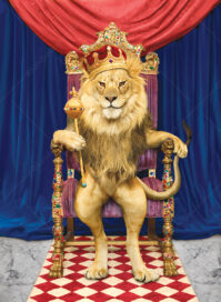 A lion, the king of beasts, sits on a throne wearing a crown.